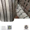نمای نزدیک پارچه رومبلی شانل با طرح چهارخانه برجسته، رنگ کرم و قهوه‌ای، بافت نرم پارچه شانل مبلی طرحدار، مناسب مبلمان راحتی و کلاسیک، کیفیت بالا
